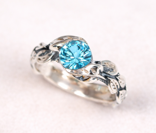 Silver leaf ring with oxidized details and blue topaz, nature inspired silver ring, vine leaf engagement ring, blue topaz ring for women, botanical silver ring, handmade leaf band with gemstone, dainty blue topaz ring, organic vine ring silver, unique engagement ring blue stone, artisan silver leaf ring, vintage style blue topaz ring, delicate stacking ring silver, women’s nature inspired jewelry