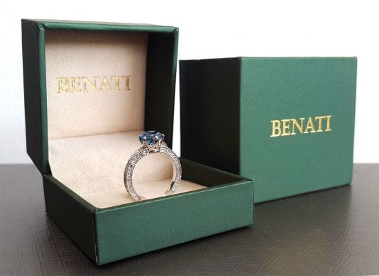 Engagement ring displayed in elegant green ring box for proposal