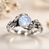 Leaf Ring With Moonstone, White Gold Moonstone Leaf Ring White gold leaf engagement ring with black rhodium detailing, featuring a glowing rainbow moonstone center stone, nature-inspired handmade design, delicate organic band, unique alternative bridal ring