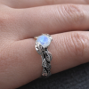 Leaf Ring With Moonstone, White Gold Moonstone Leaf Ring White gold leaf engagement ring with black rhodium detailing, featuring a glowing rainbow moonstone center stone, nature-inspired handmade design, delicate organic band, unique alternative bridal ring