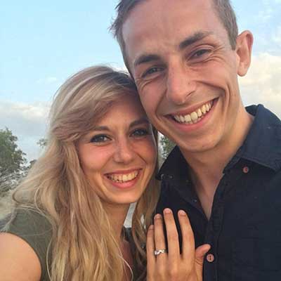 Happy women wearing engagement ring and man after proposal hugging happy benati clients