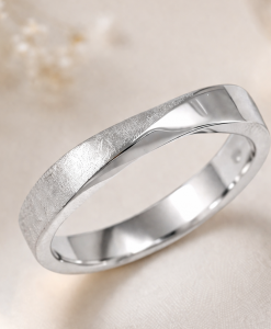 Minimalist-white-gold-twist-wedding-band-with-matte-and-polished-finish-on-soft-romantic-beige-background.png