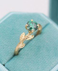 Green moissanite cushion cut ring with nature inspired theme in 14k yellow gold