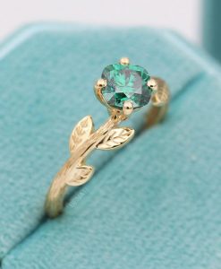 Green moissanite cushion cut ring with nature inspired theme in 14k yellow gold